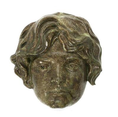 a-stoneware-mask-for-mounting-on-wall-decorated-with-green-and-brown-flecked-glaze