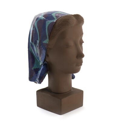 a-terracotta-bust-in-the-shape-of-a-woman-with-a-headscarf