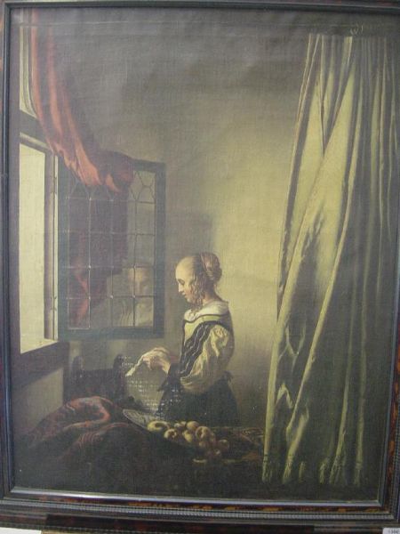woman-reading-a-letter-at-an-open-window