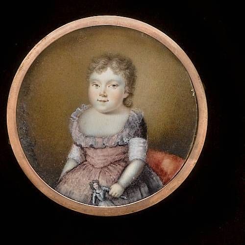 a-child-wearing-pink-dress-with-sash-and-frilled-collar-holding-a-doll-in-her-left-hand