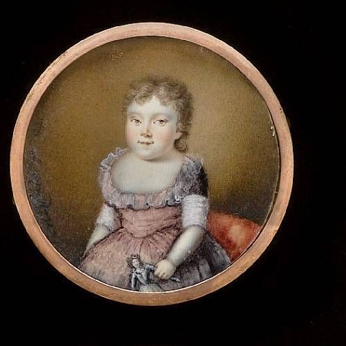 a-child-wearing-pink-dress-with-sash-and-frilled-collar-holding-a-doll-in-her-left-hand