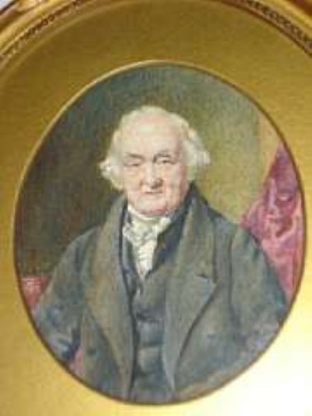 a-portrait-miniature-of-a-gentleman-seated-wearing-dark-jacket-and-white-stock-before-a-red-drape-oval