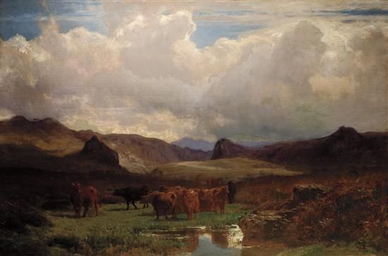cattle-grazing-on-a-hillside-beside-a-lake