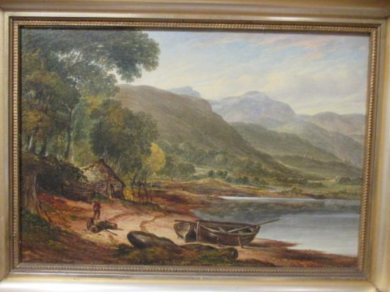 welsh-mountain-lakeside-scene-with-figure-and-boats-on-a-a-beach