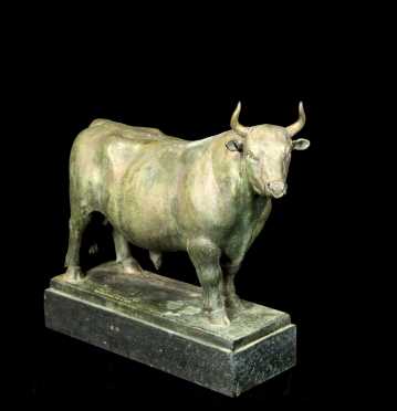 a-bull-standing-on-a-stepped-raised-plinth
