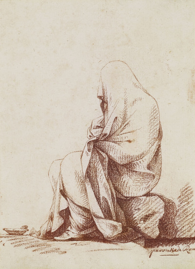 femme-assise-enveloppee-dans-un-manteau