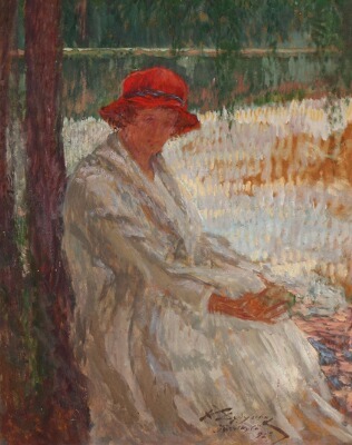 a-woman-sitting-near-a-lake-in-jarvikyla-in-finland