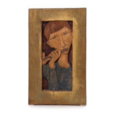 carved-wood-relief-in-the-shape-of-a-flute-player